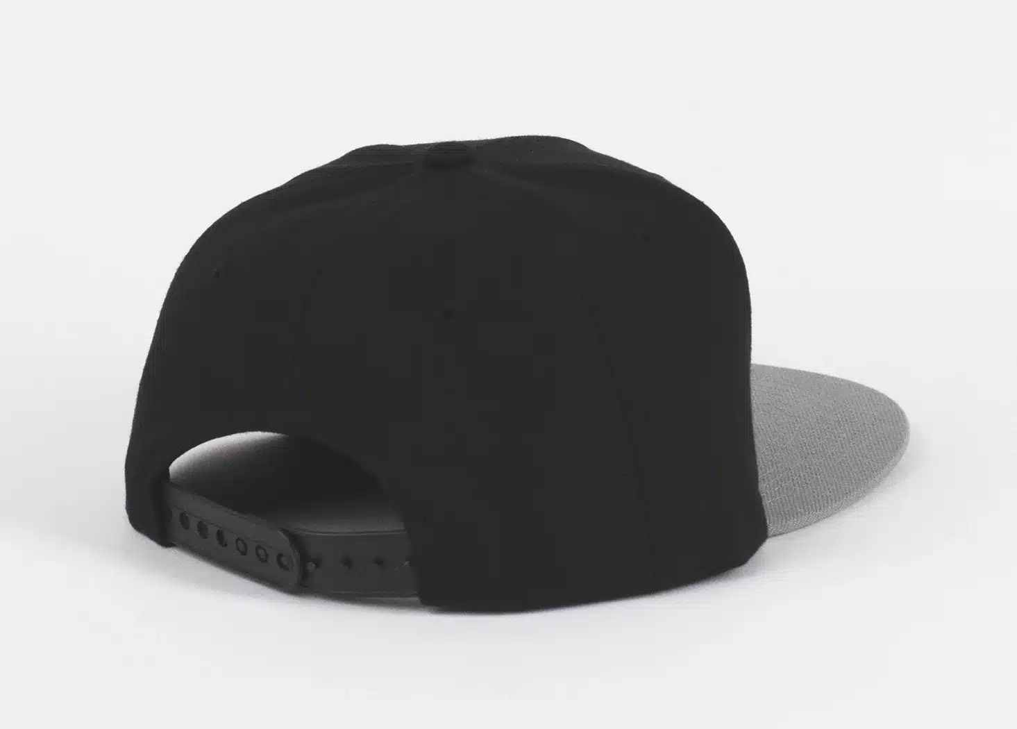 Back view of a black snapback hat with a gray brim and an adjustable strap.