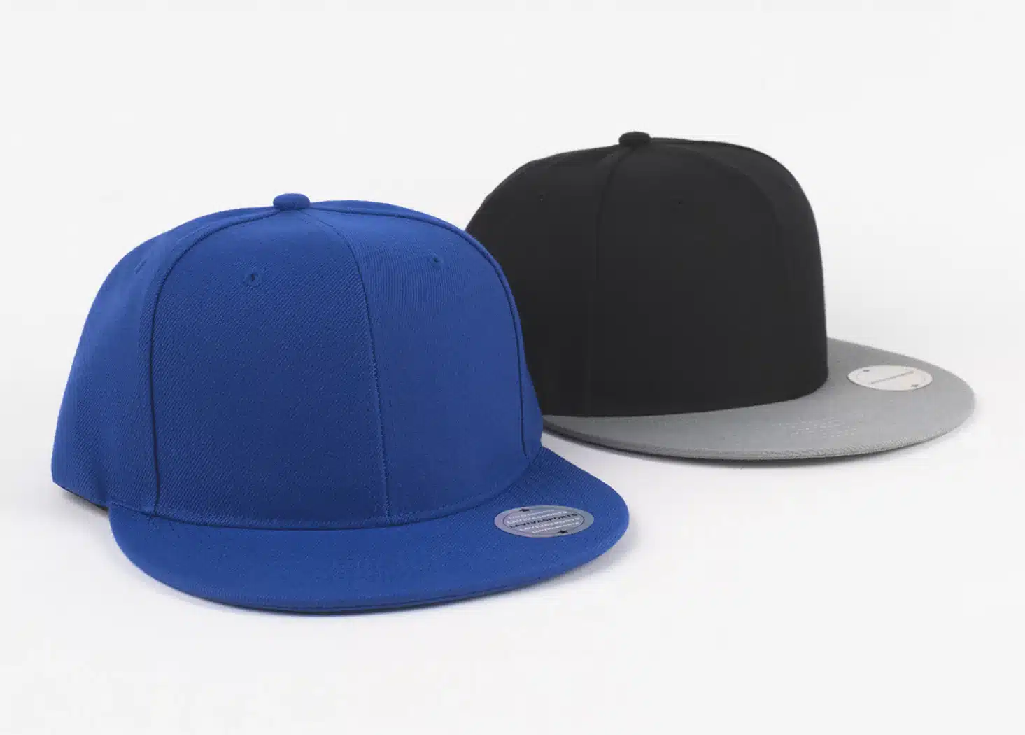 Blue and black snapback hats with flat brims on a white background.