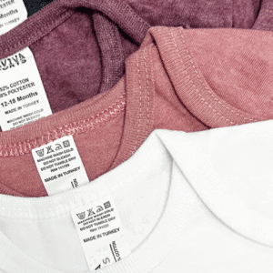 Laviva Sports baby bodysuits in multiple colors with tags showing fabric content and care instructions.