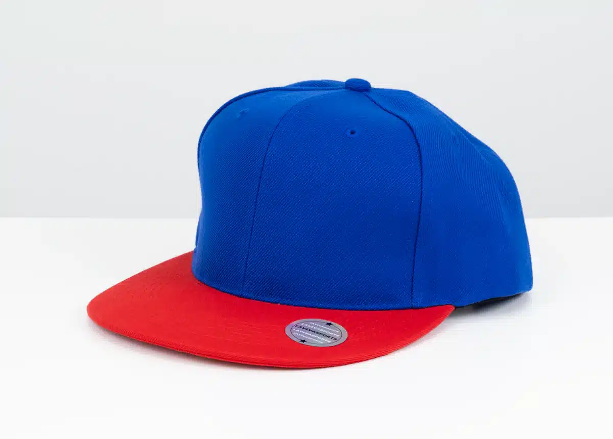Blue and red flat-brim baseball cap on a white surface.
