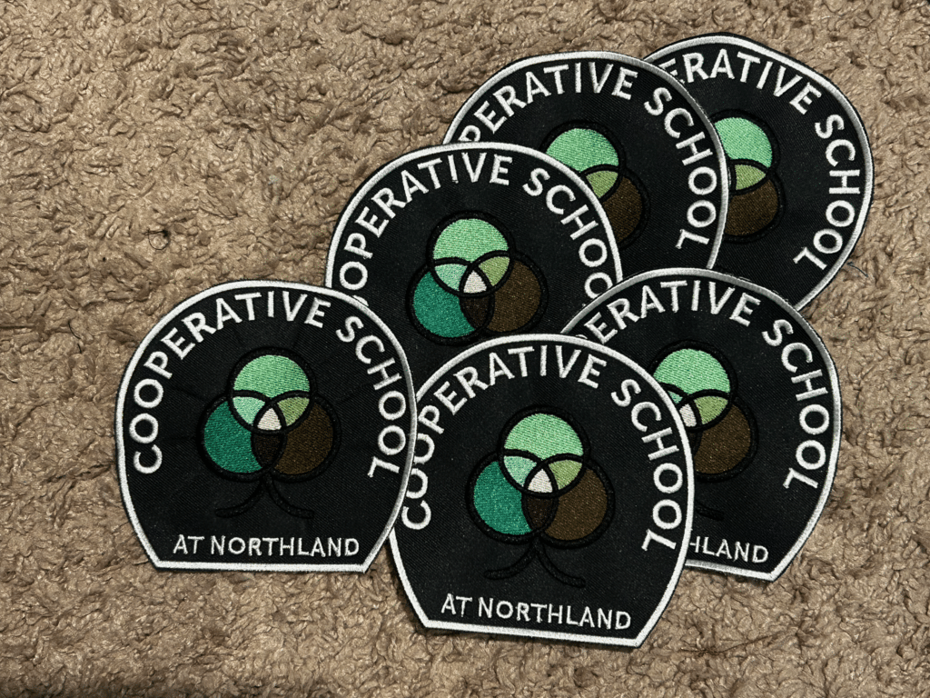 Custom embroidered patches for Cooperative School at Northland. Quality embroidery detail.