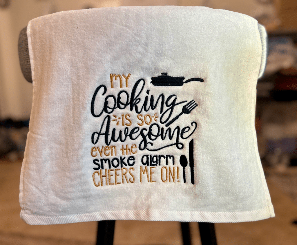 Embroidered kitchen towel: "My Cooking is so Awesome even the smoke alarm cheers me on!