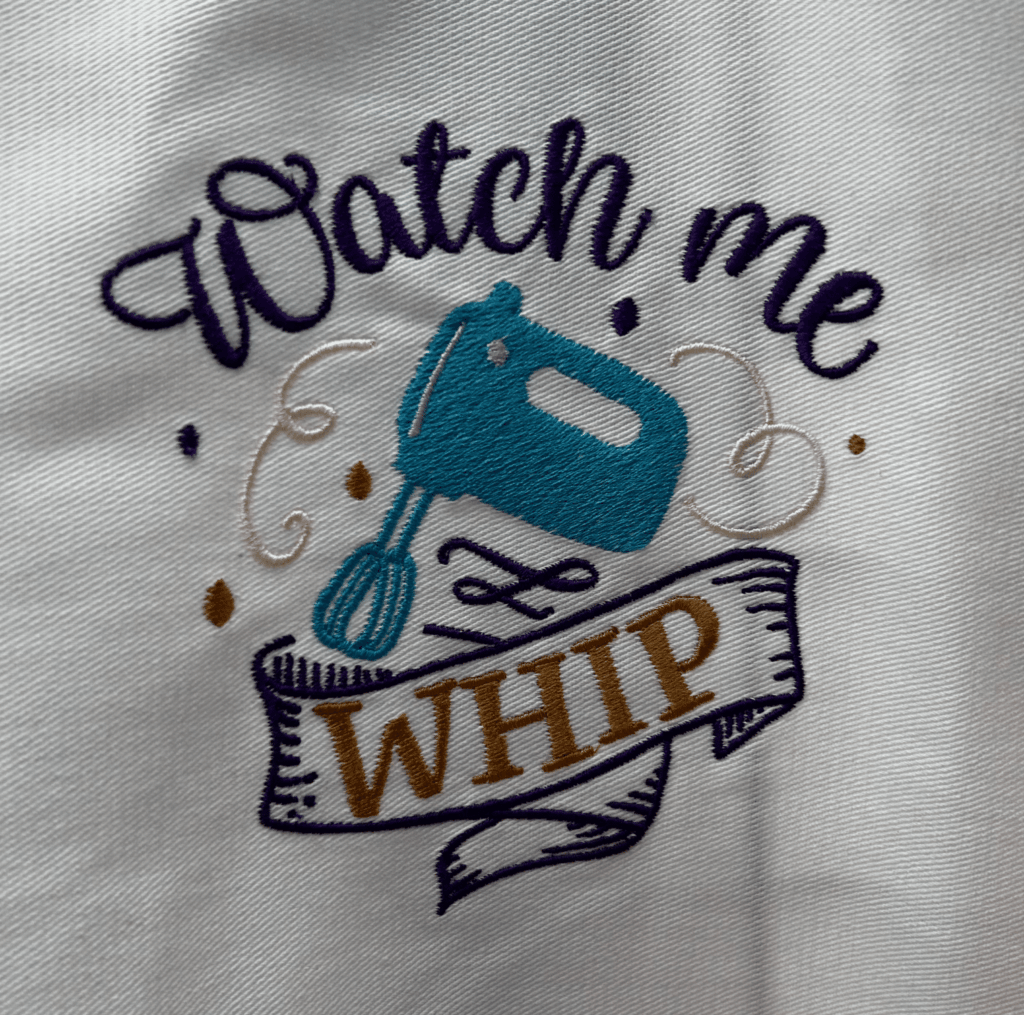 Embroidered design: "Watch me whip." Custom embroidery featuring a mixer.