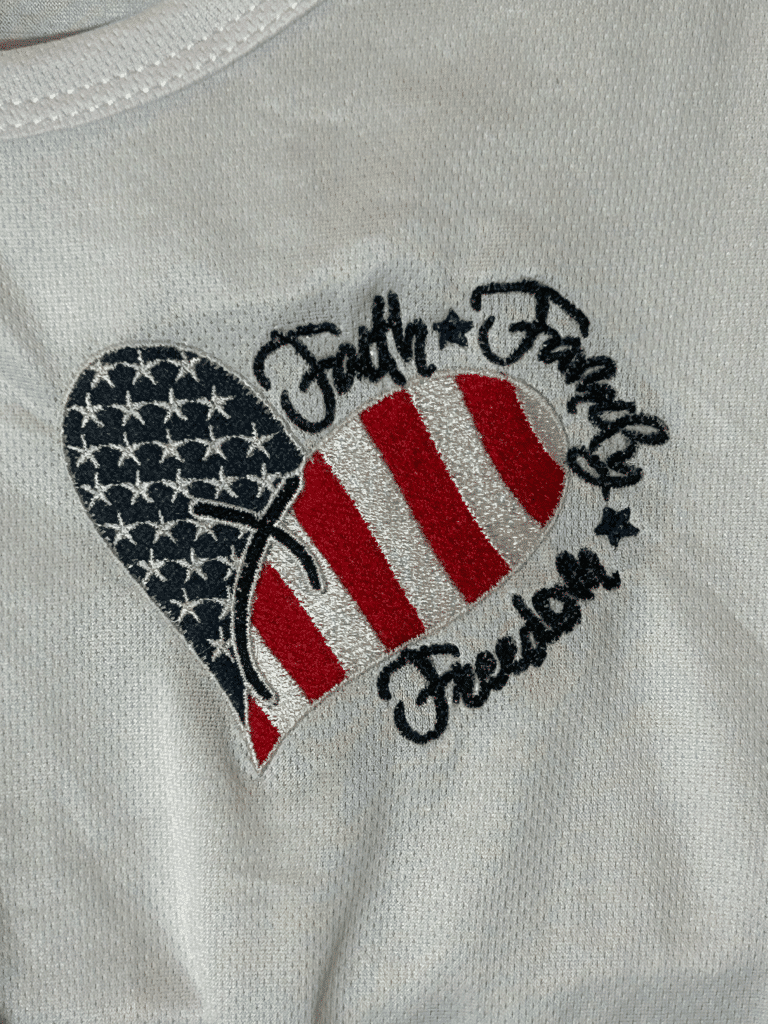 Embroidered heart with American flag design: Faith, Family, Freedom.